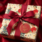 Square gift wrapped in retro Christmas wrapping paper with red bow and "For You" tag.