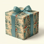 Vintage Christmas wrapping paper with a winter village scene and teal satin bow, from Wrapped Studios.