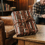 Rustic masculine cigar wrapping paper on a gift box with leather bow, by Wrapped Studios.