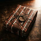 Rustic cigar wrapping paper on a gift box with a twine bow and wooden tag, by Wrapped Studios.