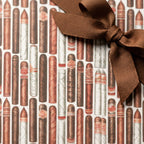 Cigar wrapping paper with a brown ribbon bow for Father's Day or groomsmen gifts by Wrapped Studios.