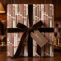 Luxury cigar wrapping paper with a brown velvet ribbon and "For Him" tag by Wrapped Studios.