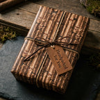 Rustic cigar wrapping paper for men's gifts, with a leather bow and tag by Wrapped Studios.
