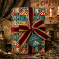 Vintage circus wrapping paper with tigers and a red velvet bow. Luxury gift wrap by Wrapped Studios.