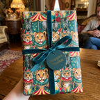Vintage circus animal wrapping paper with teal velvet ribbon by Wrapped Studios.