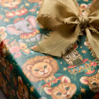 Vintage circus animal birthday wrapping paper with a gold ribbon by Wrapped Studios.