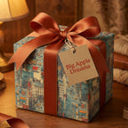 Elegant gift wrapped in vintage-style New York City wrapping paper with a copper-colored ribbon and a "Big Apple Dreams" tag.