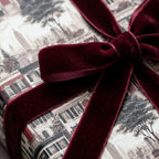 Luxury vintage New York Christmas wrapping paper with a burgundy velvet ribbon by Wrapped Studios.