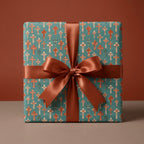 Teal Christian wrapping paper with vintage cross pattern and copper satin bow by Wrapped Studios.