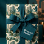 Modern city skyline wrapping paper with a teal ribbon bow and gift tag by Wrapped Studios.