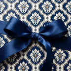 Elegant navy blue and cream damask wrapping paper tied with a satin bow, luxury gift wrap by Wrapped Studios.