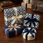 Luxury blue damask wrapping paper on elegant gift boxes with satin ribbons by Wrapped Studios.