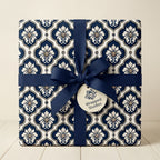 Luxury navy blue damask wrapping paper with a matching ribbon and gift tag by Wrapped Studios.