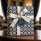 Elegant navy damask wrapping paper with a cream bow and gift tag, by Wrapped Studios.