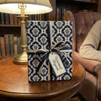 Luxury blue damask wrapping paper by Wrapped Studios on a gift with a navy and cream ribbon.