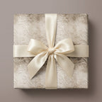 Luxury damask wrapping paper on a square gift box with a cream satin bow by Wrapped Studios.