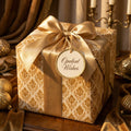 Luxury gold damask wrapping paper with a satin ribbon on a vintage holiday gift box by Wrapped Studios.