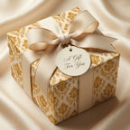 Luxury gold damask wrapping paper with champagne ribbon and gift tag by Wrapped Studios.