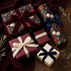 Luxury floral wrapping paper and burgundy gift wrap with velvet ribbons by Wrapped Studios.