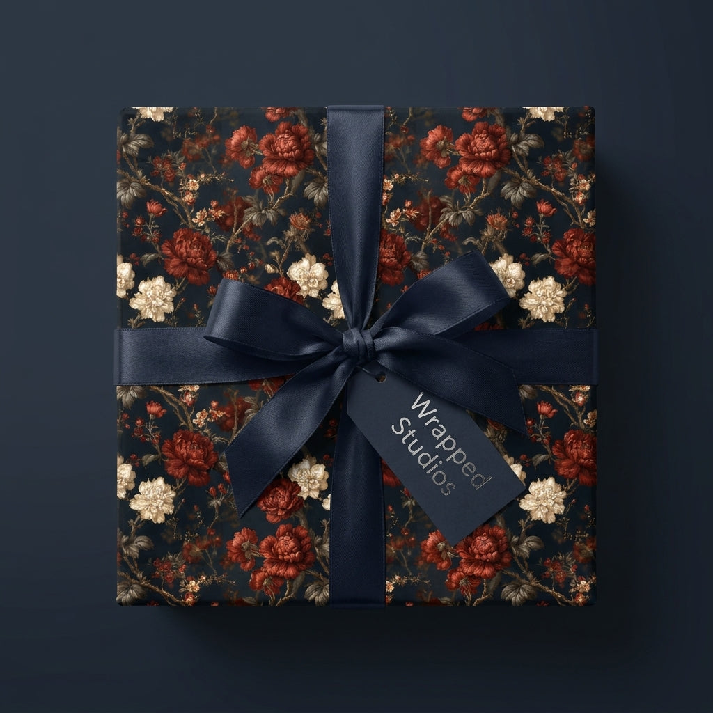 Luxury dark floral wrapping paper with red roses and navy satin ribbon by Wrapped Studios.
