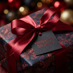 Moody floral wrapping paper with red satin bow by Wrapped Studios, perfect for luxury Christmas gift wrap.