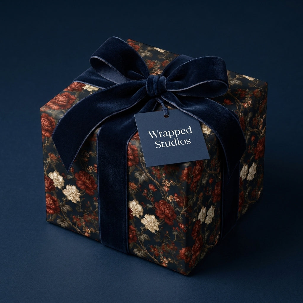 Luxury floral wrapping paper with a navy velvet bow and gift tag by Wrapped Studios.