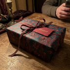 Luxury vintage floral wrapping paper in teal and burgundy with a satin ribbon by Wrapped Studios.