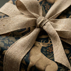 Vintage woodland deer wrapping paper with a rustic burlap ribbon bow by Wrapped Studios.