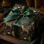 Vintage woodland Christmas gift wrap with deer, green satin bow, and Season's Greetings tag by Wrapped Studios.