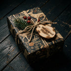 Woodland Christmas gift wrap with vintage deer pattern by Wrapped Studios on a rustic gift box.