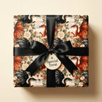 Vintage dragon wrapping paper with black satin bow on a luxury gift box by Wrapped Studios.