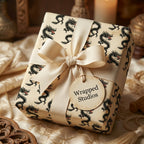 Vintage dragon wrapping paper in cream and black with a luxury ribbon bow, by Wrapped Studios.