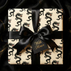 Luxury black and cream dragon wrapping paper with a satin bow and gift tag by Wrapped Studios.