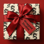 Chinese dragon wrapping paper with a luxury red satin bow and gift tag by Wrapped Studios.