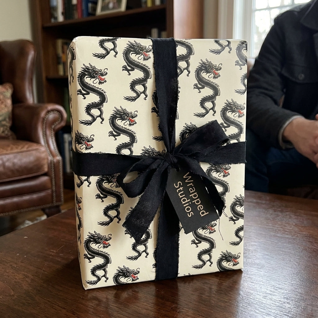 Black and cream dragon wrapping paper with a luxury black ribbon bow by Wrapped Studios.