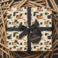Drummer wrapping paper featuring retro drum set pattern and black bow on a gift box by Wrapped Studios.