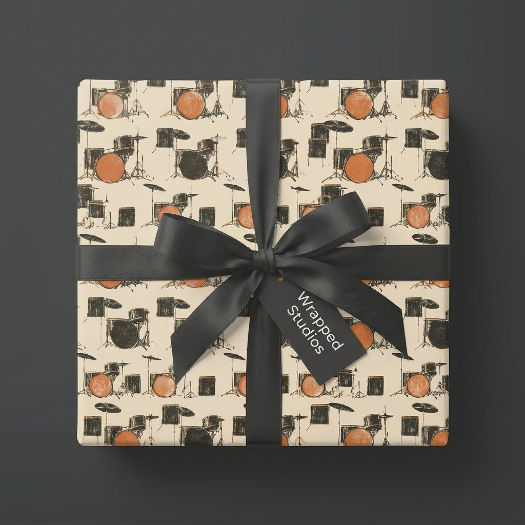 Music themed drum kit wrapping paper with a black bow on a square gift box, by Wrapped Studios.