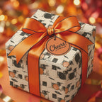 Drum kit birthday wrapping paper with luxury orange bow and Cheers tag by Wrapped Studios.