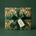 Vintage elephant Christmas wrapping paper with a green satin bow by Wrapped Studios.