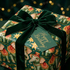 Vintage elephant birthday wrapping paper with a green velvet bow and tag by Wrapped Studios.