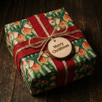 Rustic Christmas gift wrap with green vintage elephant pattern and red ribbon, by Wrapped Studios.