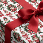 Vintage elf Christmas wrapping paper with a red satin ribbon bow by Wrapped Studios.