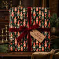 Vintage elf Christmas wrapping paper with a red velvet bow on a holiday gift by Wrapped Studios.