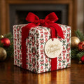Vintage elf Christmas wrapping paper with red velvet bow and gift tag by Wrapped Studios.