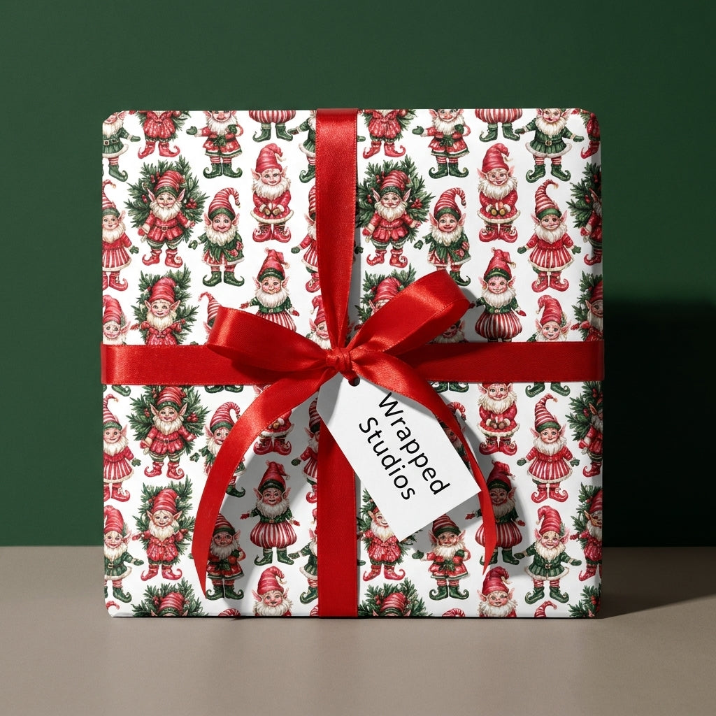 Vintage elf Christmas wrapping paper on a gift box with a red ribbon bow by Wrapped Studios.