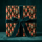 Vintage elf Christmas wrapping paper with a dark green velvet bow on a holiday gift box by Wrapped Studios.