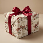 Vintage floral Christmas wrapping paper with red berries and burgundy satin bow by Wrapped Studios.