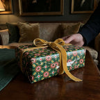 Luxury Christmas wrapping paper in a vintage green pattern with gold velvet ribbon by Wrapped Studios.