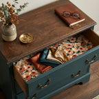 Vintage floral wrapping paper used as a drawer liner in a rustic dresser by Wrapped Studios.