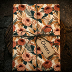 Vintage floral wrapping paper with terracotta roses and twine on a gift box by Wrapped Studios.